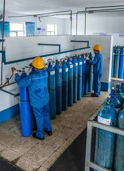 Oxygen cylinder filling process using liquid oxygen decant system in industrial gas facility with safety controls